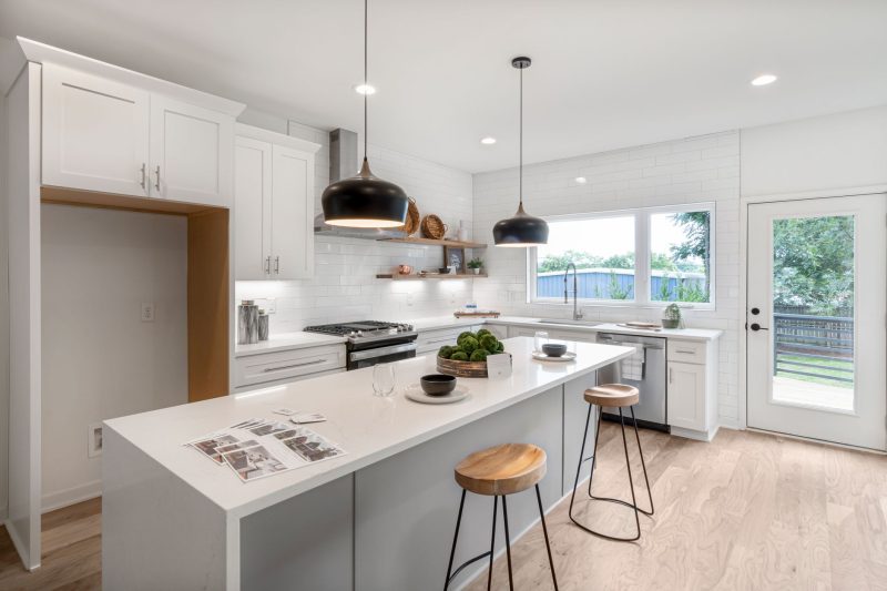 Home 14 Bright modern kitchen with white cabinetry wooden stools and 1792515725